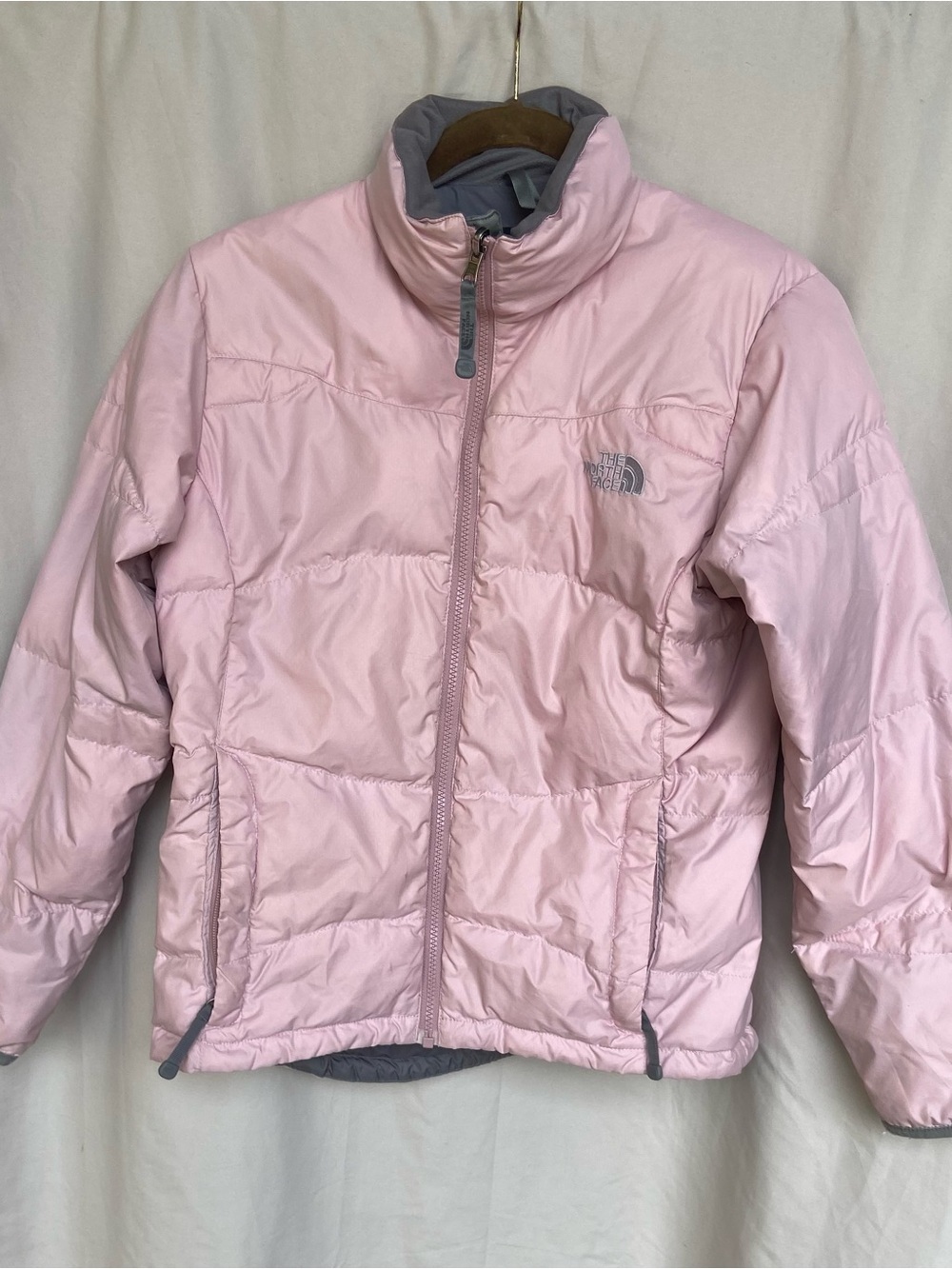 The North Face woman’s Light Pink Puffer Jacket with Gray Trim